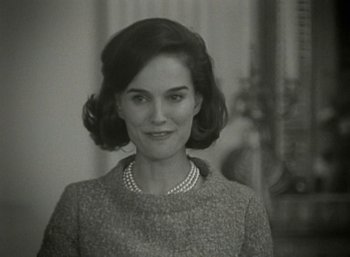 Movie still from “Jackie” (2016), directed by Pablo Larraín – A black - and - white photo of a woman in a dress; Close Up shot, Over the shoulder angle