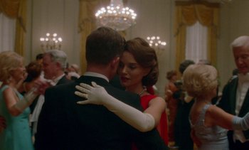 Movie still from “Jackie” (2016), directed by Pablo Larraín – A man and a woman dancing together in a ballroom; Medium shot, Over the shoulder angle
