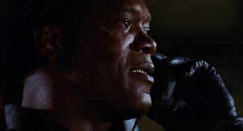 Movie still from “Jackie Brown” (1997), directed by Quentin Tarantino – A person talking on a cell phone; Extreme Close Up shot, Low angle