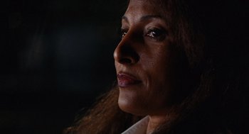 Movie still from “Jackie Brown” (1997), directed by Quentin Tarantino – A woman's face in the dark; Close Up shot, Low angle