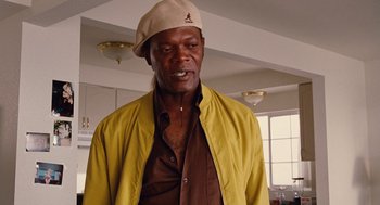 Movie still from “Jackie Brown” (1997), directed by Quentin Tarantino – An older man wearing a yellow jacket and a hat; Close Up shot, Low angle