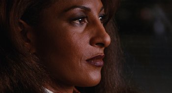 Movie still from “Jackie Brown” (1997), directed by Quentin Tarantino – A woman's face with dark makeup; Close Up shot, High angle