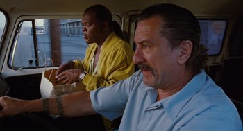 Movie still from “Jackie Brown” (1997), directed by Quentin Tarantino – Two men sitting in the back of a car; Close Up shot, Low angle