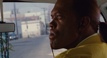 Movie still from “Jackie Brown” (1997), directed by Quentin Tarantino – A person looking out a car window; Close Up shot, Over the shoulder angle
