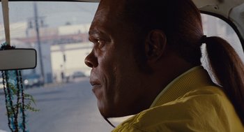 Movie still from “Jackie Brown” (1997), directed by Quentin Tarantino – A person looking out a car window; Close Up shot, Over the shoulder angle