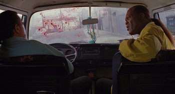 Movie still from “Jackie Brown” (1997), directed by Quentin Tarantino – A man sitting in the driver's seat of a car; Medium shot, High angle