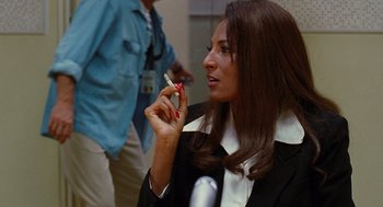 Movie still from “Jackie Brown” (1997), directed by Quentin Tarantino – A woman holding a cigarette in her hand; Close Up shot, Over the shoulder angle
