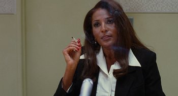 Movie still from “Jackie Brown” (1997), directed by Quentin Tarantino – A woman in a black jacket holding a cell phone; Close Up shot, Over the shoulder angle