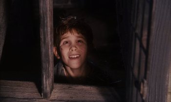 Movie still from “James and the Giant Peach” (1996), directed by Henry Selick – A young boy looking out of a window at night; Close Up shot, Low angle