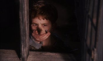 Movie still from “James and the Giant Peach” (1996), directed by Henry Selick – A young boy holding his hand to his mouth; Close Up shot, High angle