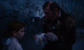 Movie still from “James and the Giant Peach” (1996), directed by Henry Selick – A man and a boy are looking at a bag; Medium shot, High angle