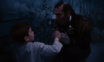 Movie still from “James and the Giant Peach” (1996), directed by Henry Selick – A man and a boy playing a video game together; Close Up shot, High angle