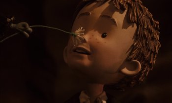 Movie still from “James and the Giant Peach” (1996), directed by Henry Selick – A doll's head with a flower in it's mouth; Close Up shot, Low angle