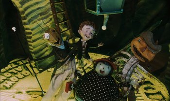 Movie still from “James and the Giant Peach” (1996), directed by Henry Selick – A group of puppets sitting on top of a floor; Wide shot, High angle