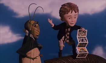 Movie still from “James and the Giant Peach” (1996), directed by Henry Selick – A cartoon of a boy and a bug looking at each other; Medium shot, Low angle