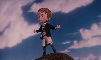 Movie still from “James and the Giant Peach” (1996), directed by Henry Selick – A cartoon of a boy standing on top of an elephant; Medium shot, Low angle