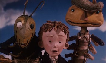 Movie still from “James and the Giant Peach” (1996), directed by Henry Selick – Three puppets with a person in a suit; Close Up shot, Low angle