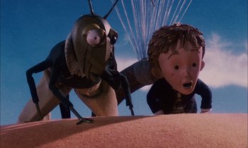 Movie still from “James and the Giant Peach” (1996), directed by Henry Selick – A bug and a boy in a field; Medium shot, Low angle