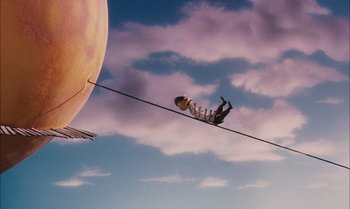 Movie still from “James and the Giant Peach” (1996), directed by Henry Selick – A man is balancing on a wire in front of the moon; Extreme Wide shot, Low angle