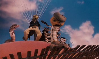 Movie still from “James and the Giant Peach” (1996), directed by Henry Selick – A group of people standing on top of a fence; Wide shot, Low angle