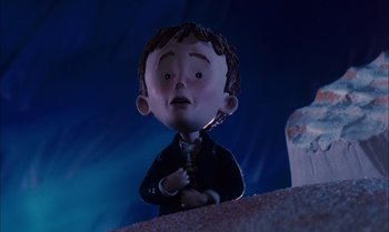 Movie still from “James and the Giant Peach” (1996), directed by Henry Selick – A cartoon of a boy with a sad face; Medium shot, Low angle