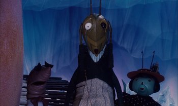 Movie still from “James and the Giant Peach” (1996), directed by Henry Selick – A woman with a creepy mask on her head; Medium shot, Low angle