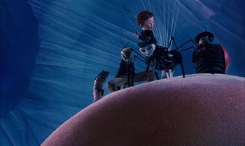 Movie still from “James and the Giant Peach” (1996), directed by Henry Selick – A group of people standing on top of a ball; Wide shot, High angle