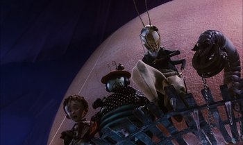 Movie still from “James and the Giant Peach” (1996), directed by Henry Selick – A group of puppets hanging from a string; Wide shot, Low angle