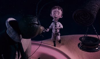Movie still from “James and the Giant Peach” (1996), directed by Henry Selick – A cartoon of a boy holding a tie and standing in front of a sink; Medium shot, High angle