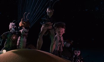 Movie still from “James and the Giant Peach” (1996), directed by Henry Selick – A group of people standing next to each other in the dark; Wide shot, Low angle