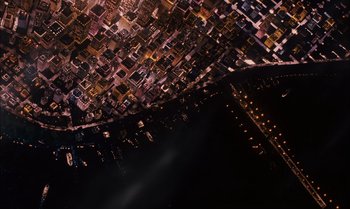Movie still from “James and the Giant Peach” (1996), directed by Henry Selick – An aerial view of a city at night with lights; Extreme Wide shot, Overhead angle