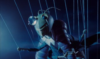Movie still from “James and the Giant Peach” (1996), directed by Henry Selick – An insect is sitting in a cage in the dark; Extreme Close Up shot, Low angle