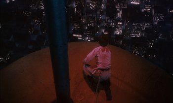 Movie still from “James and the Giant Peach” (1996), directed by Henry Selick – A man sitting on the floor of a building at night; Wide shot, Overhead angle