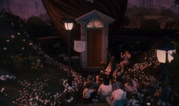 Movie still from “James and the Giant Peach” (1996), directed by Henry Selick – A group of people sitting in front of a door; Extreme Wide shot, High angle