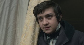 Movie still from “Jane Eyre” (2011), directed by Cary Joji Fukunaga – A young man wearing a suit and bow tie; Close Up shot, High angle