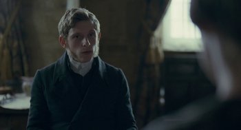 Movie still from “Jane Eyre” (2011), directed by Cary Joji Fukunaga – A man in a black coat and a white shirt; Close Up shot, Over the shoulder angle