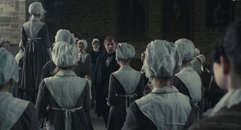 Movie still from “Jane Eyre” (2011), directed by Cary Joji Fukunaga – A group of people dressed in period clothing; Wide shot, Over the shoulder angle