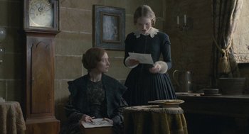 Movie still from “Jane Eyre” (2011), directed by Cary Joji Fukunaga – Two women are sitting at a table and one is reading a letter; Medium shot, Over the shoulder angle