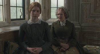 Movie still from “Jane Eyre” (2011), directed by Cary Joji Fukunaga – Two women sitting next to each other in front of a window; Medium shot, Over the shoulder angle