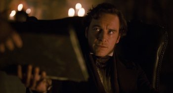 Movie still from “Jane Eyre” (2011), directed by Cary Joji Fukunaga – A person holding a book; Close Up shot, Low angle