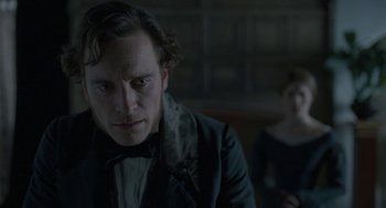 Movie still from “Jane Eyre” (2011), directed by Cary Joji Fukunaga – A man and a woman in a dark room; Close Up shot, Over the shoulder angle