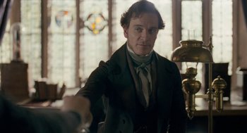 Movie still from “Jane Eyre” (2011), directed by Cary Joji Fukunaga – A man standing in front of stained glass windows; Medium shot, Over the shoulder angle