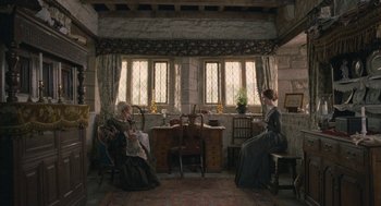 Movie still from “Jane Eyre” (2011), directed by Cary Joji Fukunaga – Two women sitting in chairs in front of a window; Wide shot, High angle