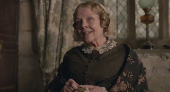 Movie still from “Jane Eyre” (2011), directed by Cary Joji Fukunaga – An older woman in a victorian dress holding a piece of cake; Close Up shot, Over the shoulder angle