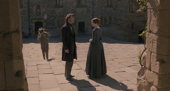 Movie still from “Jane Eyre” (2011), directed by Cary Joji Fukunaga – A man and a woman standing in front of each other; Wide shot, High angle