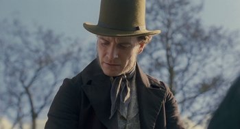 Movie still from “Jane Eyre” (2011), directed by Cary Joji Fukunaga – A person wearing a top hat; Close Up shot, Low angle