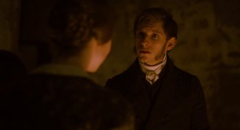 Movie still from “Jane Eyre” (2011), directed by Cary Joji Fukunaga – A man in a black suit and a woman in a white dress; Close Up shot, Over the shoulder angle