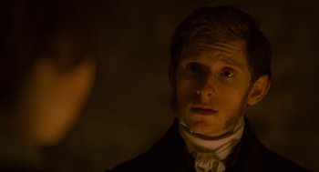 Movie still from “Jane Eyre” (2011), directed by Cary Joji Fukunaga – A young man in a black suit and white shirt; Close Up shot, Over the shoulder angle