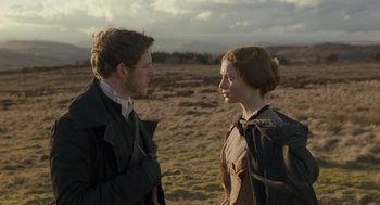 Movie still from “Jane Eyre” (2011), directed by Cary Joji Fukunaga – A man and a woman standing next to each other in a field; Medium shot, Over the shoulder angle