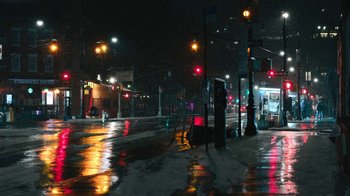 A city street at night lit by street lights